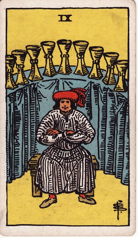カップの9（Nine of Cups）のカード画像。ライダー版タロット